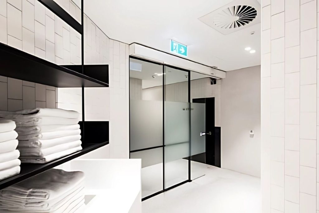 STA21 automatic sliding doors gallery 6 Automatic sliding door with frosted privacy glass in a modern change room.