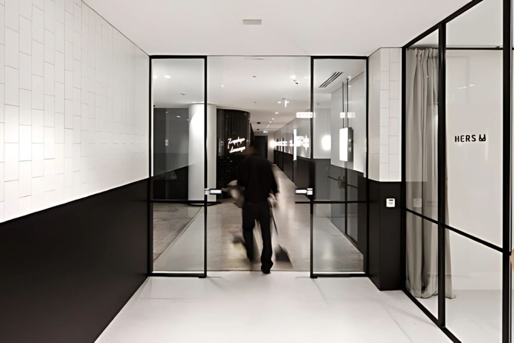 STA21 automatic sliding doors gallery 3 Hands-free automatic sliding doors in a commercial interior with high-end finishes.