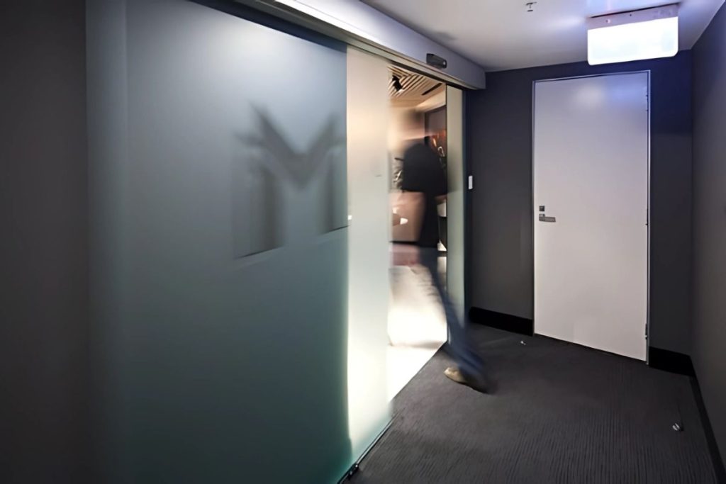 STA21 automatic sliding doors gallery 5 Interior corridor featuring a sleek automatic sliding door.