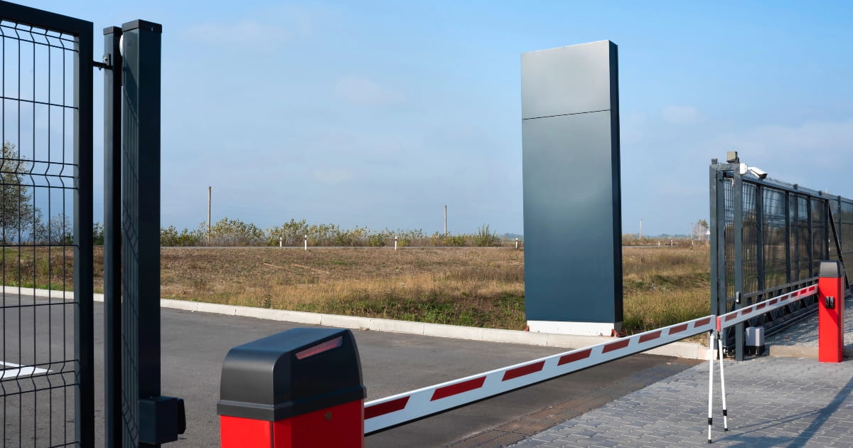 Vehicle access point with boom gate.