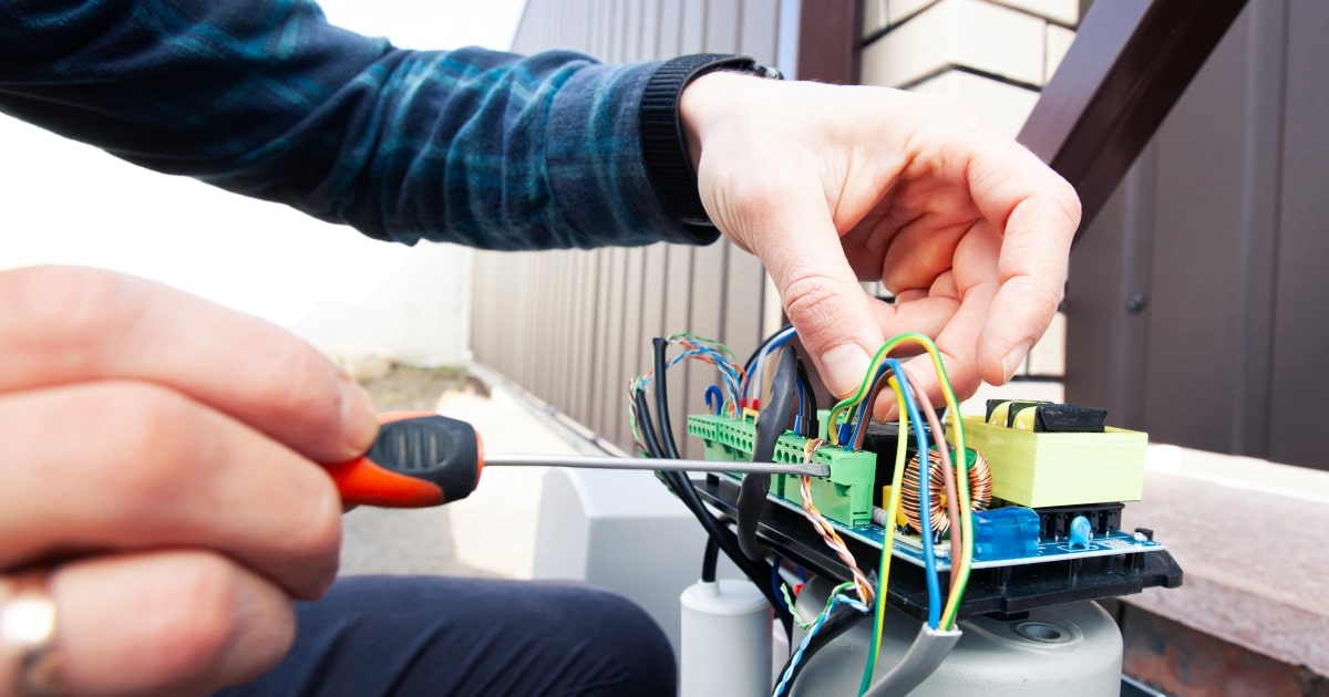 Automatic security gate control system undergoing professional repairs.