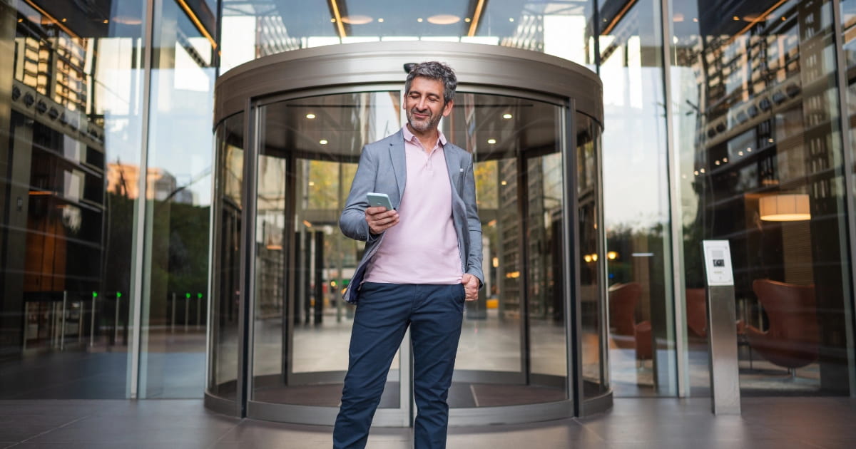 Automatic revolving door at a modern commercial building entrance.